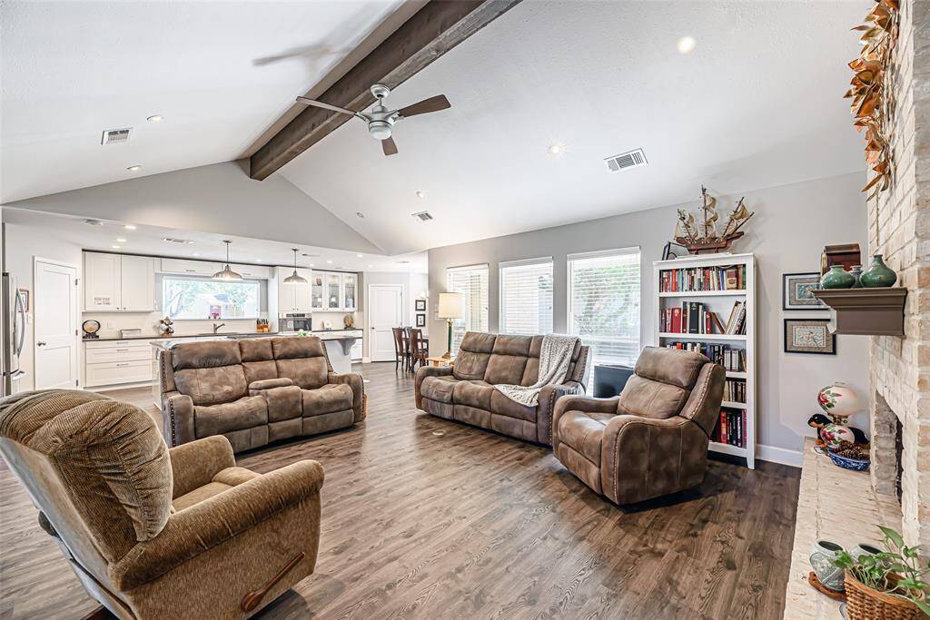 Another view of the family room showcasing the large picture windows over looking the backyard.
