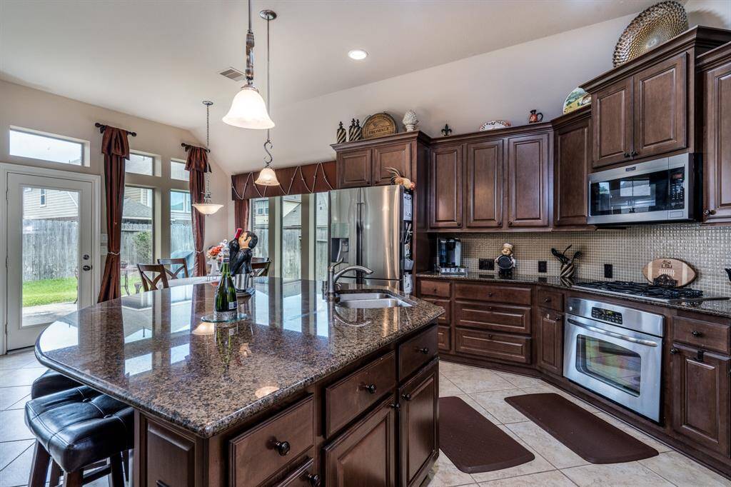 The kitchen area has a large island with breakfast bar. The island also features TONS of storage space.