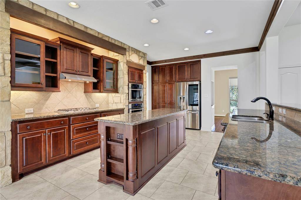 The kitchen features granite counter tops, stainless steel appliances and lots of cabinet space
