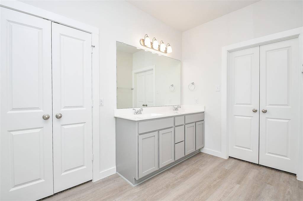 Enjoy the convenience of a dual-sink vanity in this stylish primary bathroom, perfect for getting ready in the morning with ease.