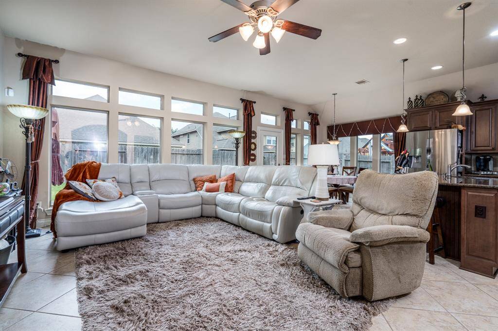 The living area features tile flooring, high ceilings and AMPLE amounts of natural light from the wall of windows!
