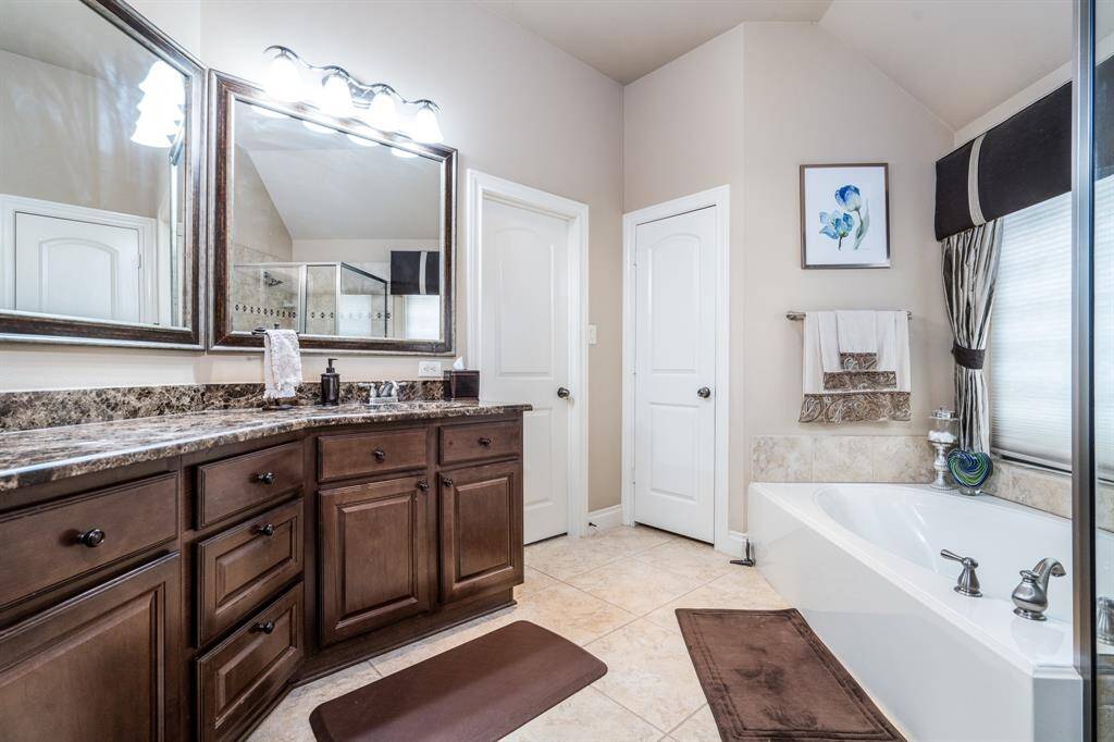 Primary Bath has a deep tub and walk in shower. Large vanity with tons of storage