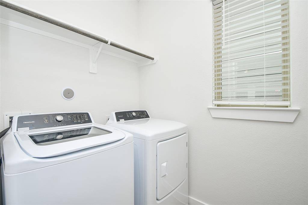 The utility room is equipped with a washer and dryer, adding a touch of convenience to everyday living.