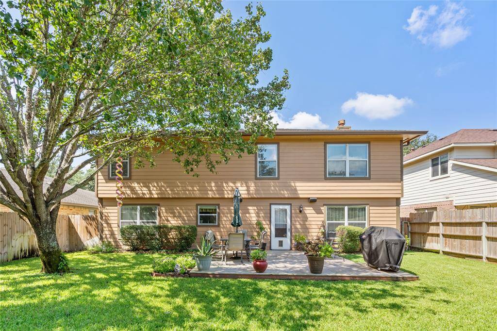 Your amazing new home features a well-maintained backyard with a mature tree, a patio area with plenty of space for outdoor seating and a barbecue grill.