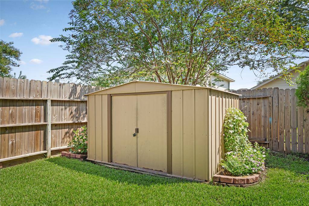 Your backyard storage shed has two beautiful raised beds landscaping providing a pleasant outdoor space.