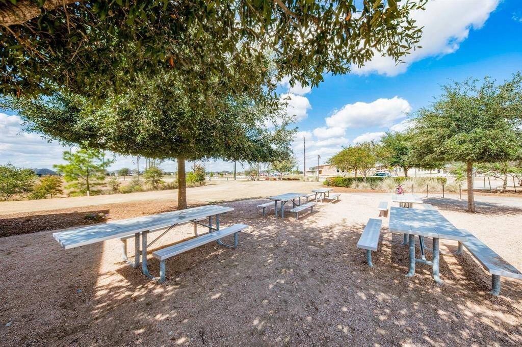 The community amenities also include picnic tables and benches, perfect for enjoying outdoor gatherings or relaxing under the shade of nearby trees.