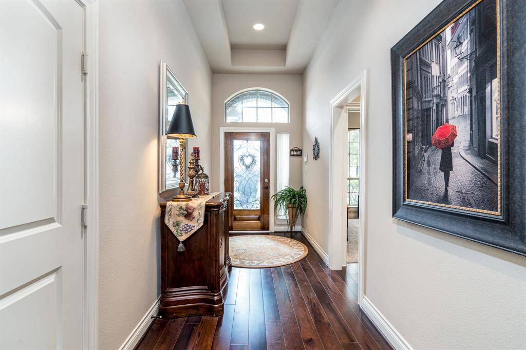 Entry way with engineered Wood flooring, tray ceilings