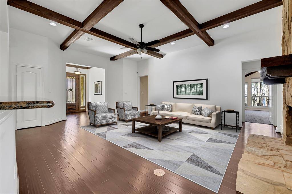The living area has a wood burning fireplace with stone surround - virtually staged