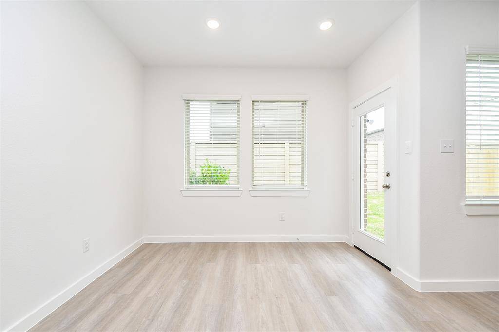 Enjoy the beauty of the outdoors while dining in this light-filled space. Large windows and a glass-paneled door leading to the backyard offer tranquil views and ample natural light.