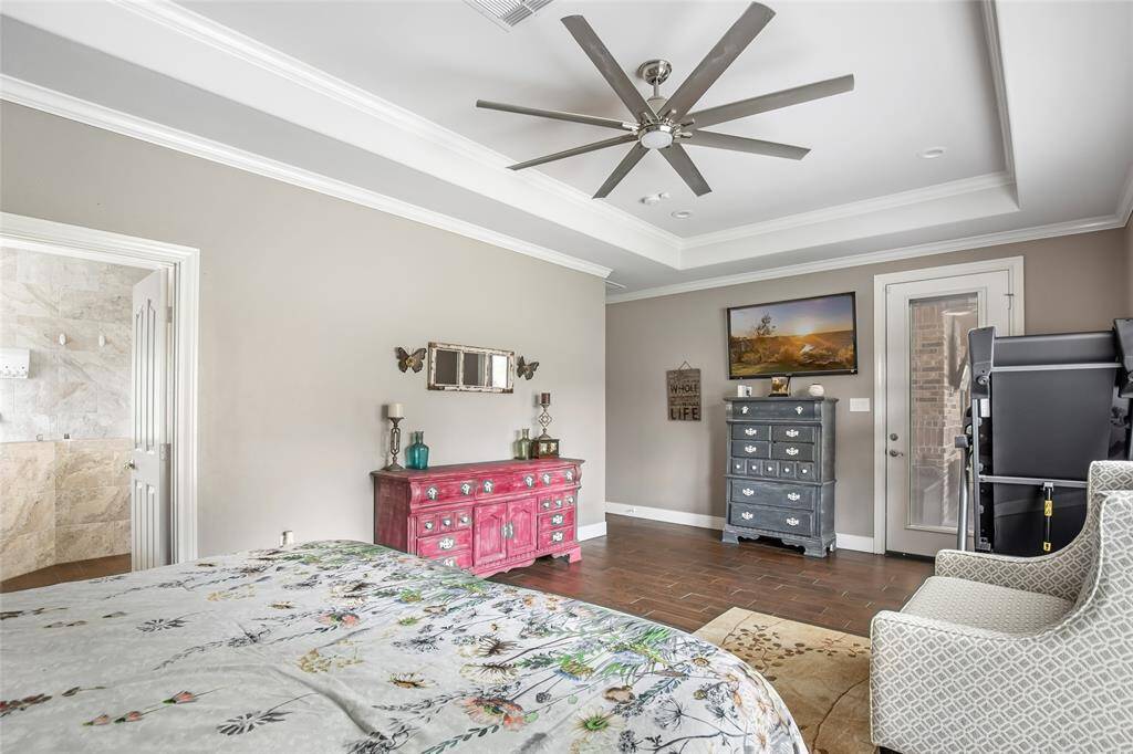 Primary bedroom with vaulted ceilings and access to back porch