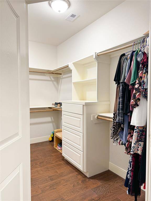 Large primary closet connected to bathroom.