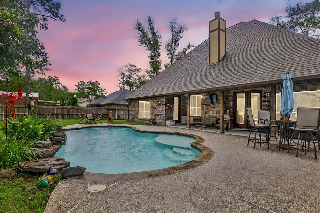 Private pool with large tanning ledge and rock water feature.