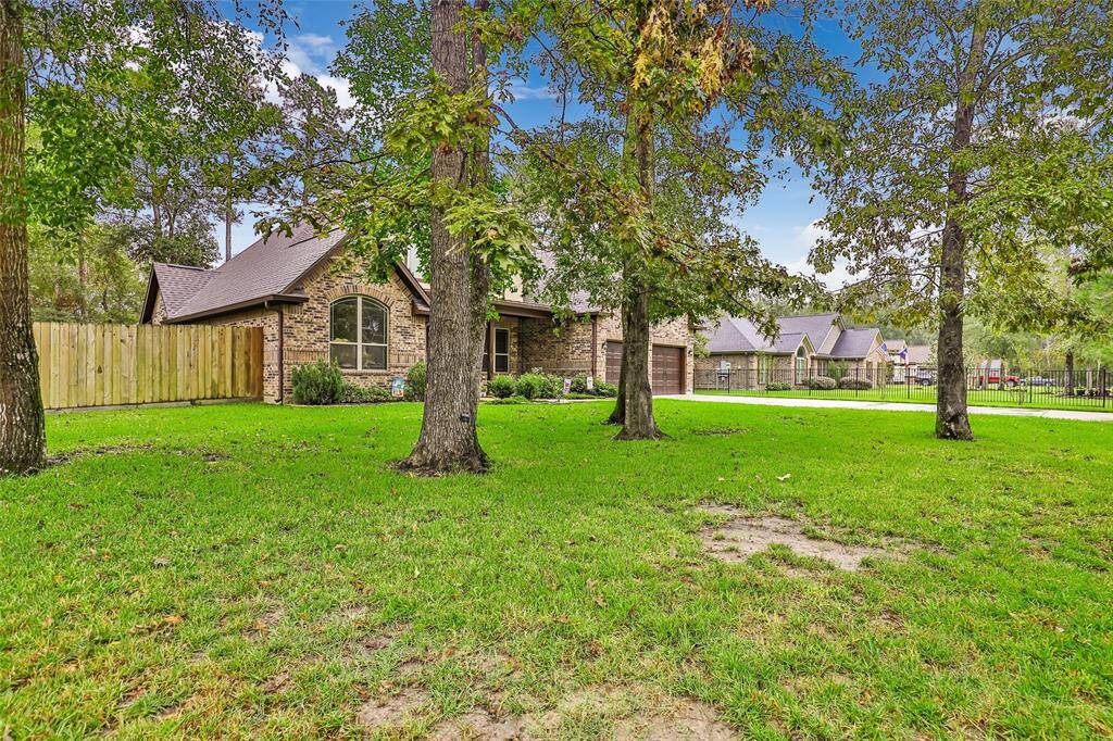 Front of home. Large mature trees in front yard.
