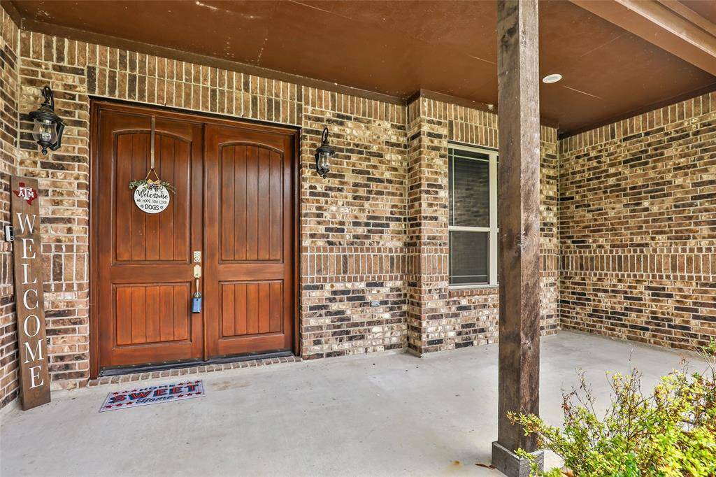 Front porch, with beautiful wood doors.