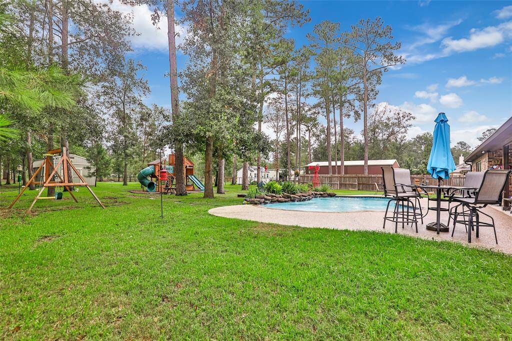 Pool and view of the large backyard with ample shade trees
