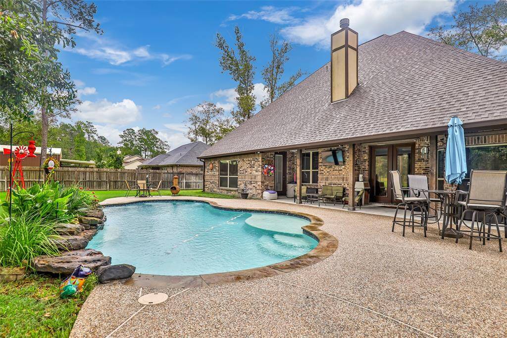 Pool with large tanning ledge and rock water feature