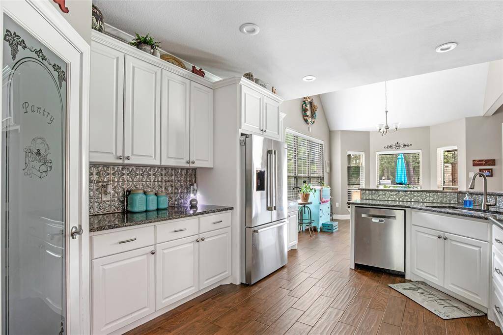 Kitchen and walk-in pantry with frosted glass door.