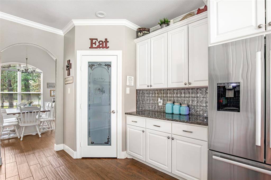 Kitchen and walk-in pantry with frosted glass door.