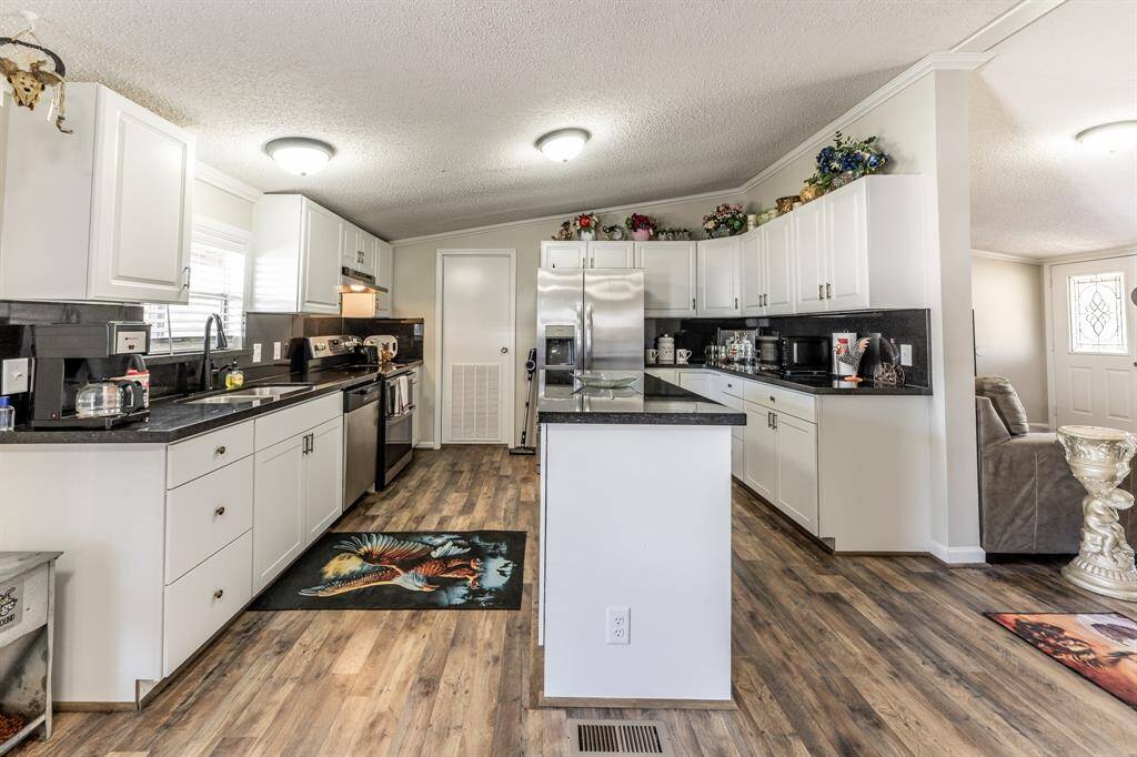 Modern kitchen with sleek countertops, stainless steel appliances, and ample cabinetry, perfect for entertaining and culinary creativity.