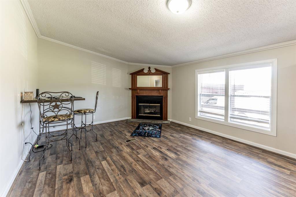 Cozy corner fireplace enhances the charm of the second living area.