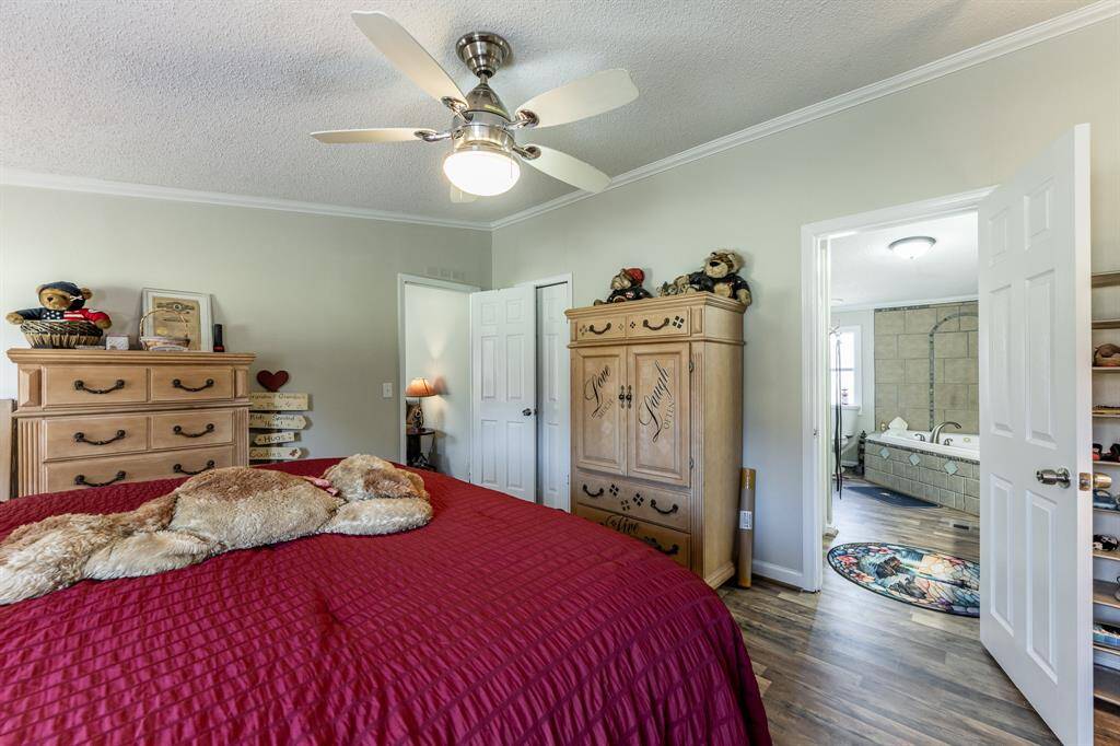 Spacious primary bedroom with direct access to a private bath.