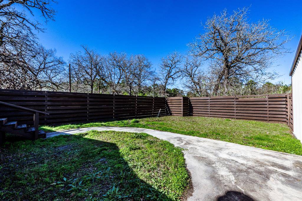 Secluded backyard oasis with a private fence, perfect for relaxation and outdoor activities.