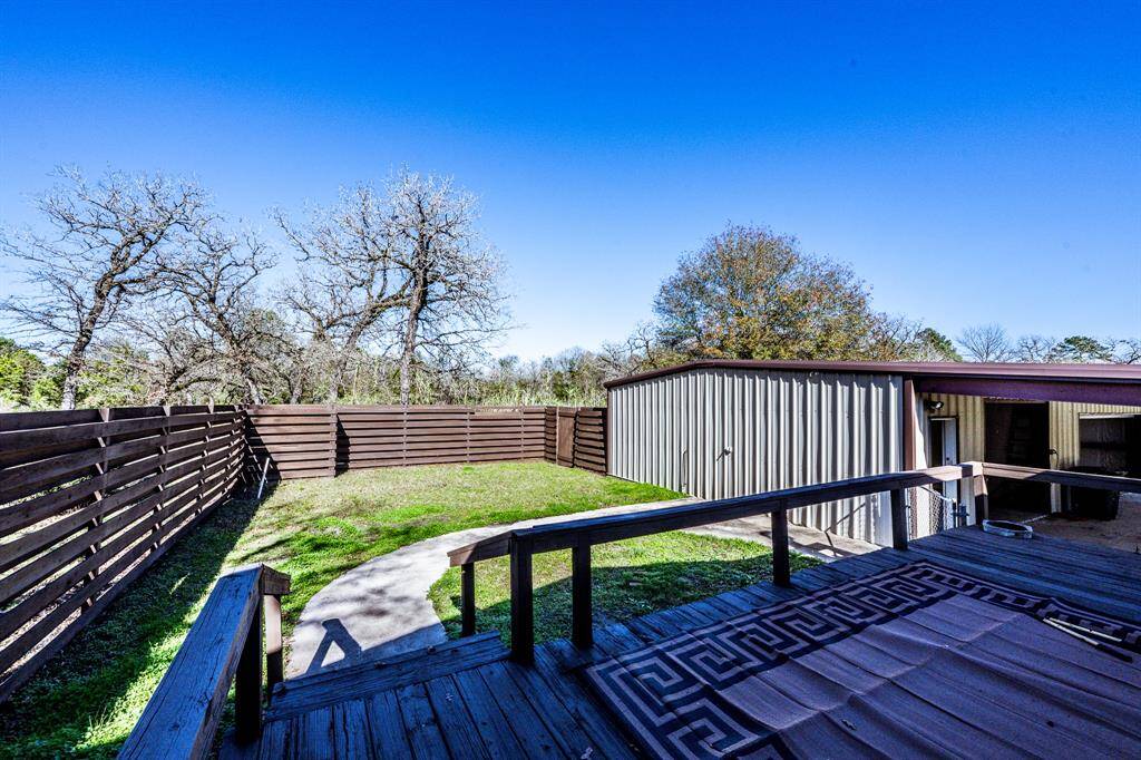 Private retreat with deck, perfect for a pool or hot tub addition.