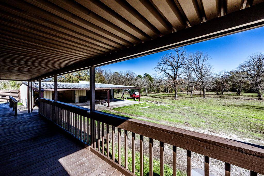 Taken from back porch showing building with extended 4 car carport
