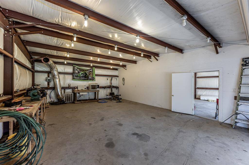 Spacious shop area with a doorway leading to an equally sized adjoining space. Ideal for versatile use.