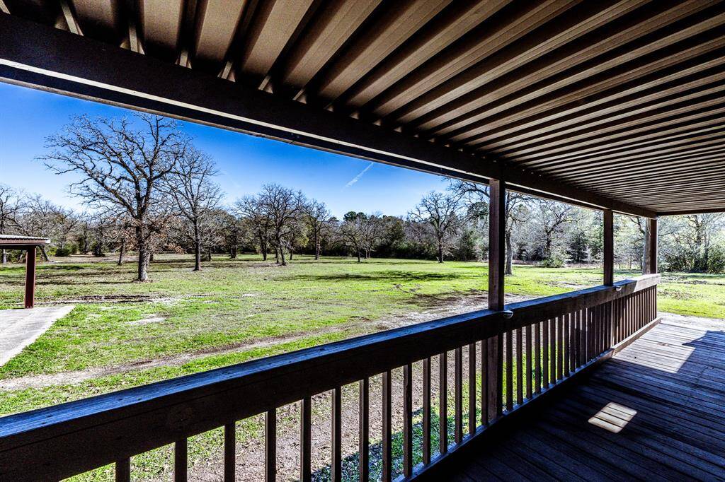 Expansive backyard views from the porch, offering serene natural beauty and ample space.