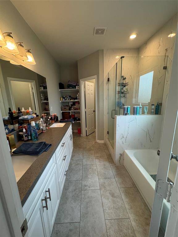 Main bathroom offers separated bathtub, stand up shower, and double vanity.