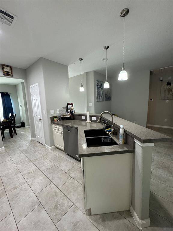 The kitchen is well-lit, providing ample storage space for kitchen essentials.