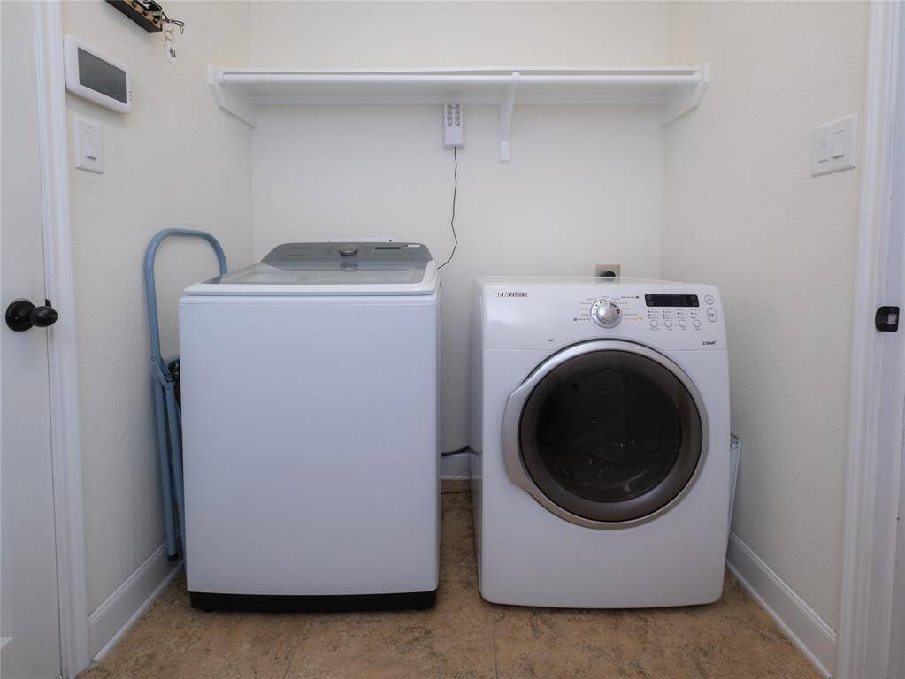 The laundry is off the kitchen and has extra storage!