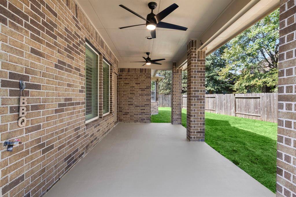 This extended covered patio offers the ultimate outdoor space with dual ceiling fans to keep you cool during gatherings.