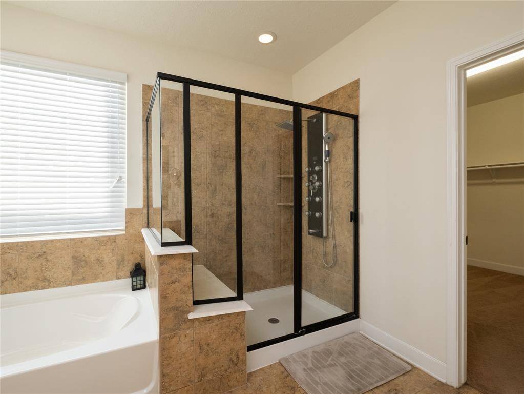 Check out this large walk in shower with an amazing shower system!