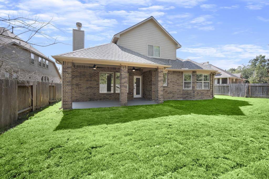 Enjoy the outdoors in this large backyard featuring a fully covered patio, perfect for gatherings or quiet relaxation.