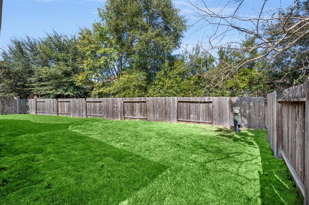 This fully fenced backyard offers privacy and plenty of space for outdoor activities, whether it's a barbecue, gardening, or simply enjoying the fresh air.