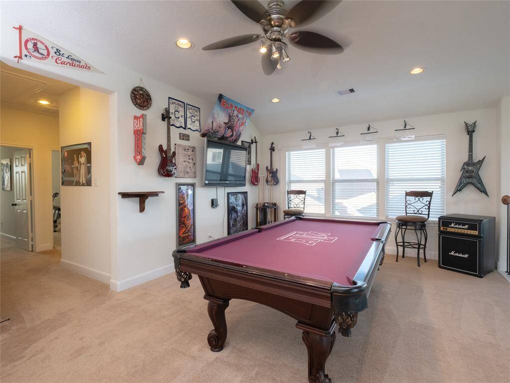 Another view of this gameroom area! Pool table and TV mounted to the wall will stay with the home!