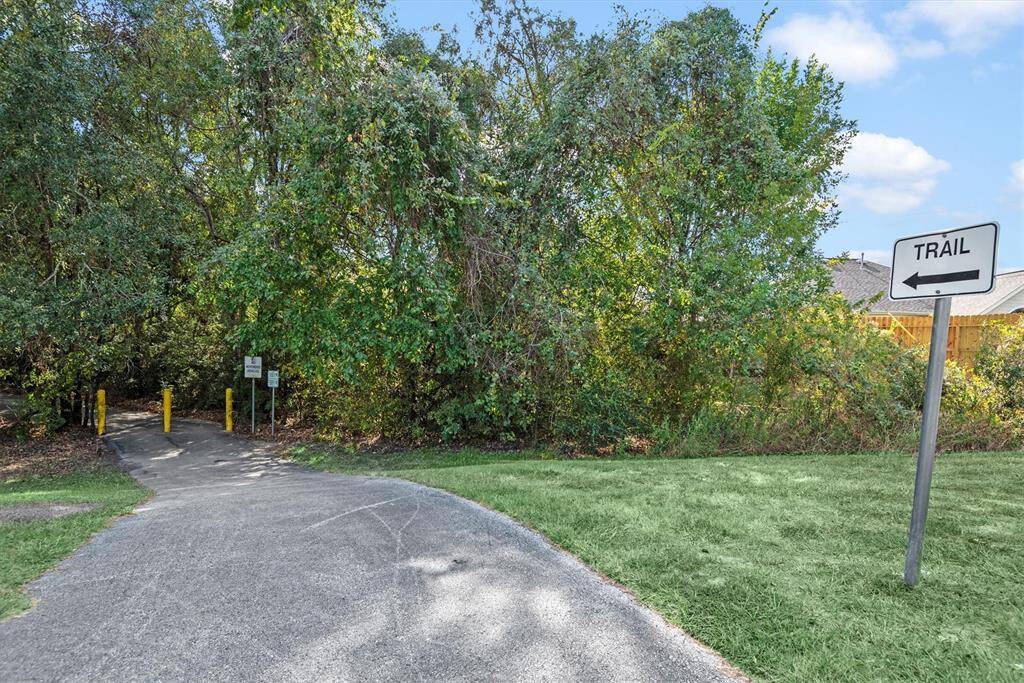 The property features convenient access to a paved trail surrounded by natural greenery, perfect for outdoor activities and enjoying nature. The trails of Faulkey Gulley Hike and Bike easily connect to Cypress Creek Hike and Bike Trails and Kickerillo Mischer Preserve.