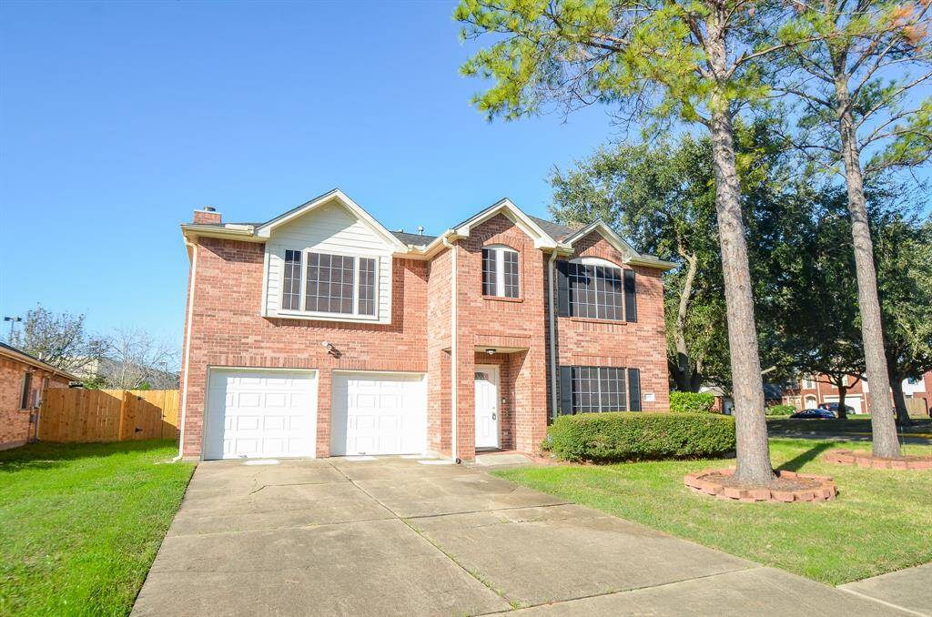 This charming two-story brick home features a double garage, large windows, and a welcoming front yard with mature trees. Ideal for family living.