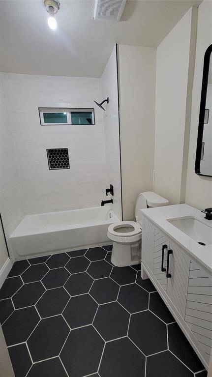 Fully remodeled bathroom. All white bathroom vanity with a precious black flooring.