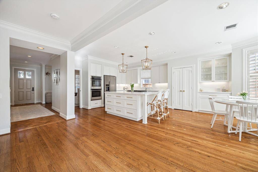 Extensively remodeled kitchen with island range, bar and large soft close storage drawers.