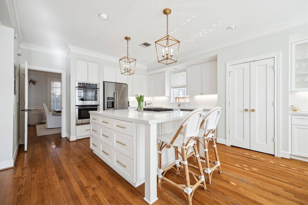 Beautifully remodeled kitchen with closeup of large task island & breakfast bar.
