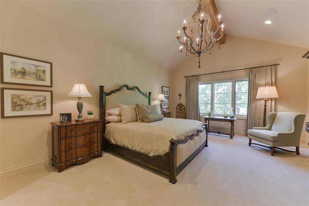 Another great asset to this well-planned home - an additional PRIMARY BEDROOM (20 X 15), this one upstairs and includes pitched ceiling (exposed wood beam/hanging chandelier/recessed lighting/built-in speakers, carpeted flooring, window with designer drapery, coffee bar and en suite bath.