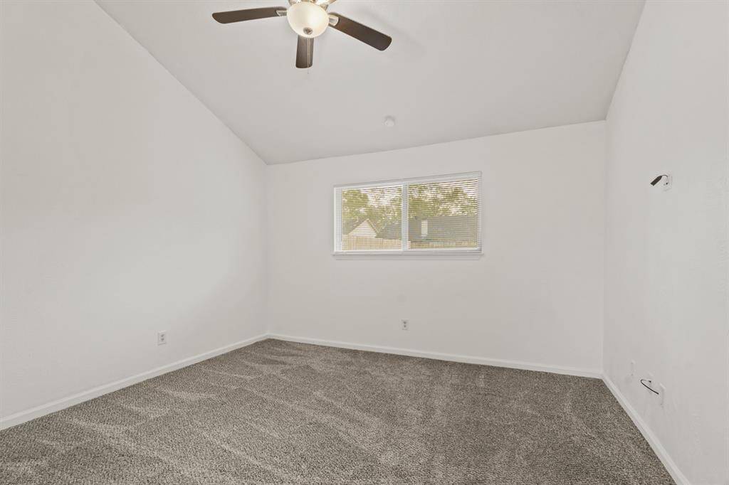 Third bedroom features awindow and plush carpet.