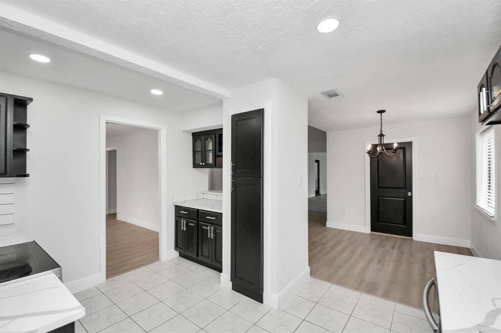 Angled View Showing Kitchen, Formal Dining, and Entry to the Living Area