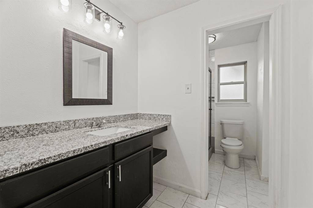 Secondary bathroom features awalk-in shower and long vanitywith plenty of counter space.
