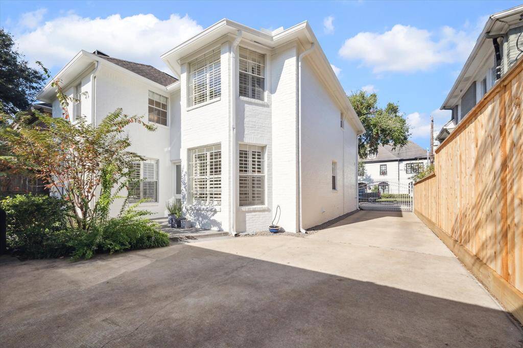 Gated driveway with high privacy fence.