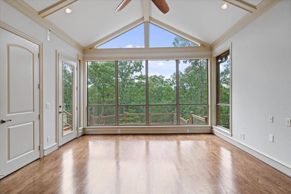 Inviting study with panoramic garden views through a stunning wall-to-wall window.