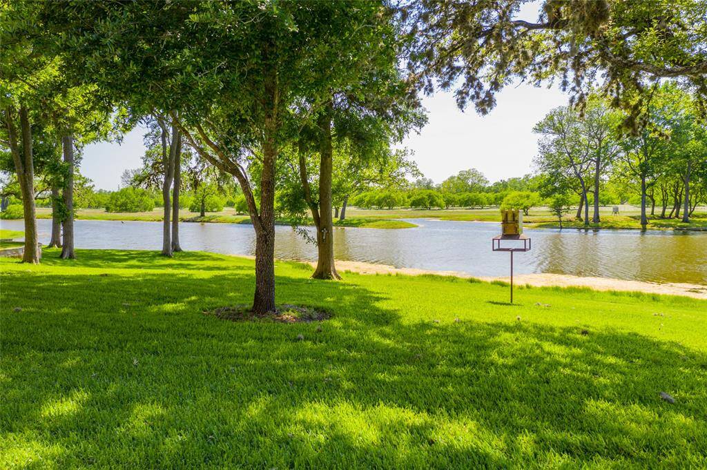 View from the Guest House and Main House looking across the grassed area to the lake beyond.